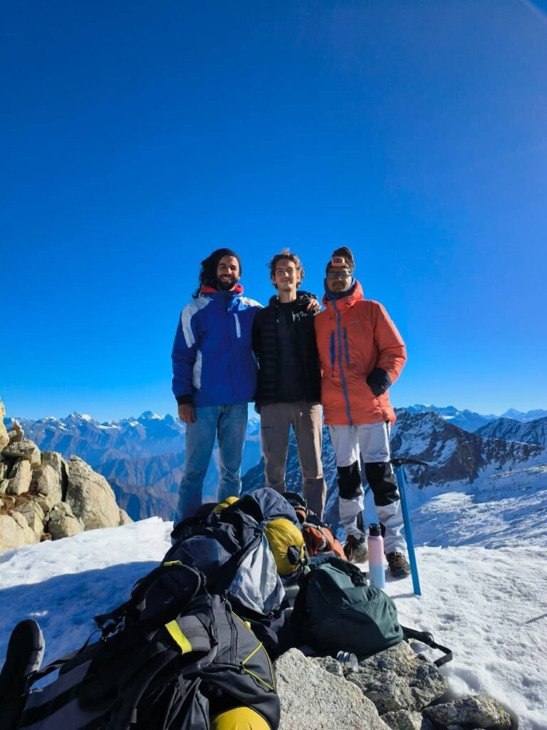 A summit in the Himalaya, ice axe and packs on the snow